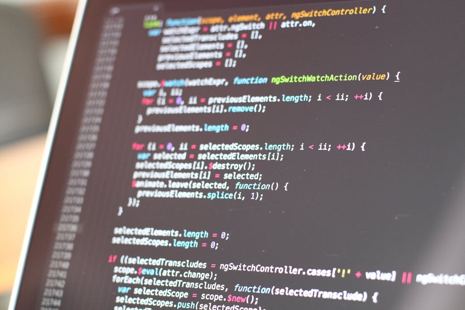 A close-up view of a computer screen displaying lines of colorful programming code, including syntax highlighted in pink, blue, green, yellow, and white. The code appears to be JavaScript, with functi